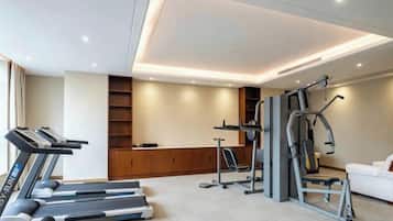 A home gym with treadmills, a stationary bike, and a weight machine.