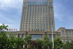 A multi-story building with a large number of windows and a sign indicating it is a hotel. - Zhan Ye International Hotel (Shou County)