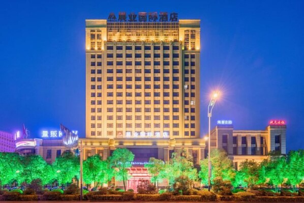 A multi-story hotel building with a prominent sign at the top.