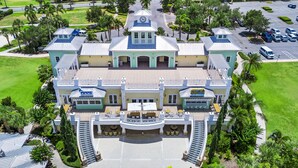 A large, multi-story building with a central tower, a restaurant, and a lounge area. - Inviting Home near Disney with Waterpark & Resort Access at Encore Resort -. (Kissimmee)
