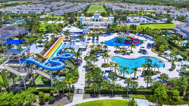 A resort with a large pool, water slides, and a tennis court. - Inviting Home near Disney with Waterpark & Resort Access at Encore Resort -. (Kissimmee)