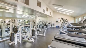 A gym with treadmills, weight machines, and mirrors. - Pool, 2 Mi to Beach! Extended Stay in San Diego (San Diego)