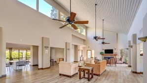 A spacious living area with high ceilings, multiple ceiling fans, and large windows providing natural light. - Pool, 2 Mi to Beach! Extended Stay in San Diego (San Diego)