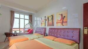A hotel room with two beds, a hanging chair, and artwork on the wall.