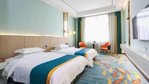 A hotel room with two beds, a small table, two chairs, a TV, and a window with curtains. - Wanli Hotel (Chengdu Head Office) (Chengdu)