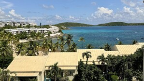 A coastal resort with multiple-story buildings, a beach, and a view of the sea.