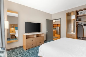 A hotel room with a bed, a TV, a wardrobe, and a bathroom visible through an open door. - Candlewood Suites Chester Richmond by IHG (Chester)