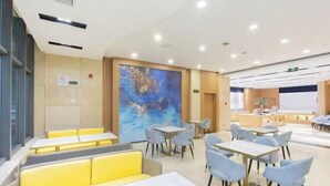 A modern hotel lobby with seating areas, a large abstract painting on the wall, and a reception desk. - Huali Hotel (Kunshan Golden Eagle International Shopping Center) (Kunshan)