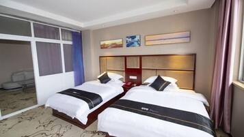 A hotel room with two beds, a large mirror, and a view of the city.