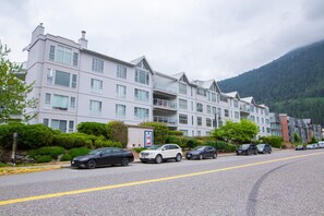 A multi-story hotel with a modern design, featuring balconies and large windows.