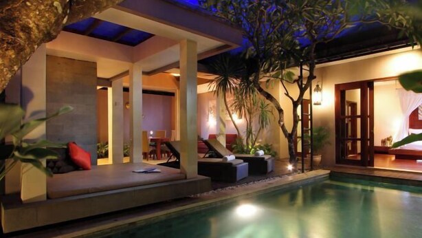 A poolside area with a seating area, a covered section, and a view of the pool. - Aria Exclusive Villas & Spa (Bali)