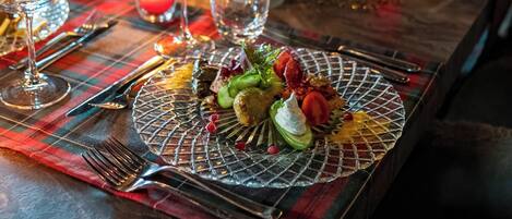 A table set with wine glasses, cutlery, and a decorative centerpiece.