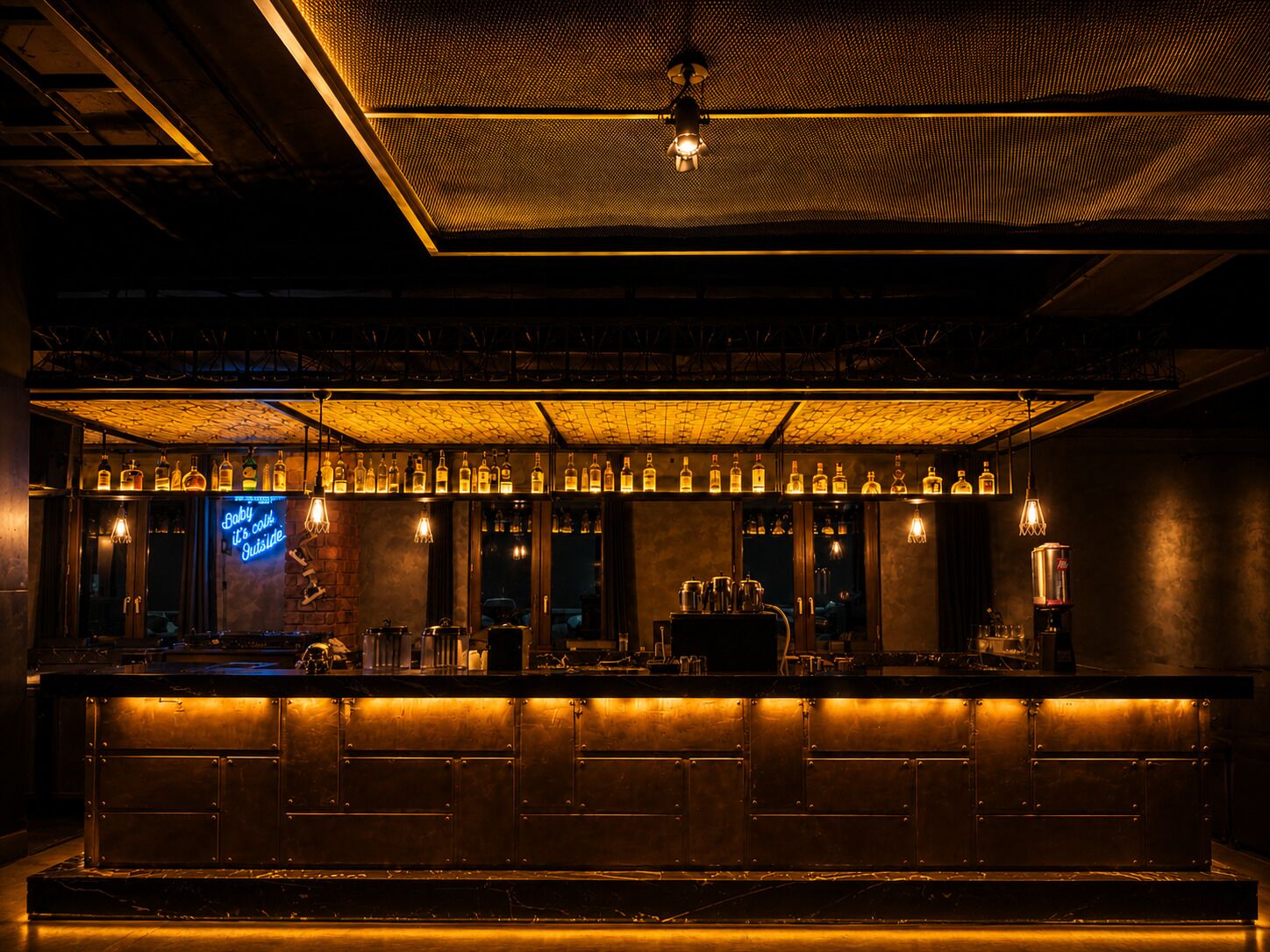 A bar with a long counter, bottles of liquor, and a neon sign.