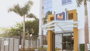 A modern building with a glass entrance, a visible address number, and a sign indicating a garage.