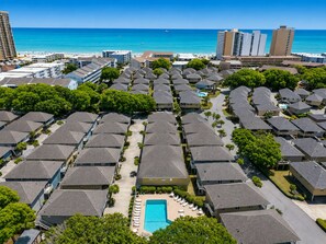 A residential area with a central swimming pool surrounded by houses.