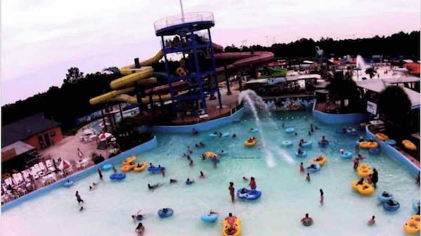 A water park with multiple water slides and a large pool area.