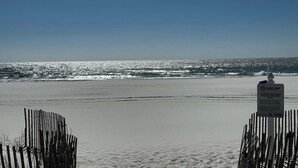 A beach with a sign instructing to leave only footprints and remove personal items daily. - Affordable updated 2BR family retreat with pool (Gulf Shores)