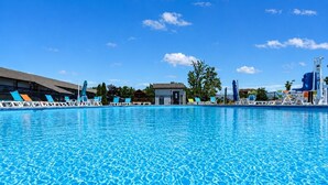 A swimming pool with lounge chairs and a small building in the background. - Pleasure Point at Kimberling Crossing (Kimberling City)