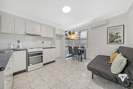 Fridge, microwave, oven, stovetop. KozyGuru | Cozy 1-Bedroom Granny Flat in Fairfield
