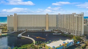 A large hotel with multiple high-rise buildings, a marina, and a waterfront view. - Palm Tree Paradise – Free Beach Chairs & Umbrella, 5 Pools, Beach Access | Laketown Wharf 1531 (Panama City Beach)