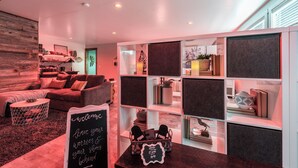 A modern interior with a cozy seating area, a bookshelf, and a chalkboard sign. - Welcoming Guest Suite in Snohomish (Snohomish)
