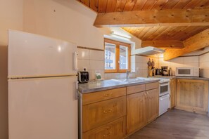 Enjoy cooking in this well-equipped kitchen with oven, microwave, and sink.