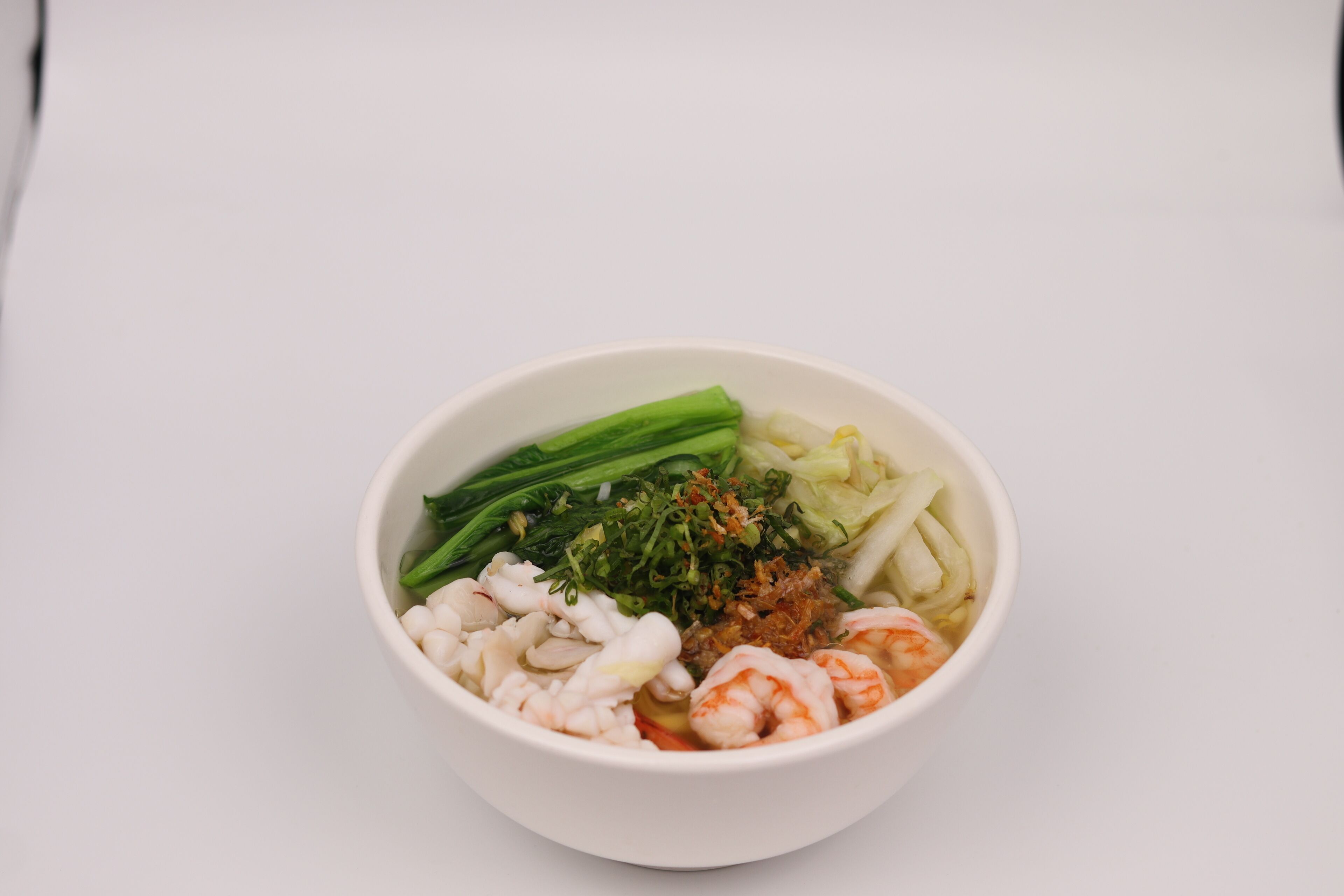 A bowl of food with various ingredients.