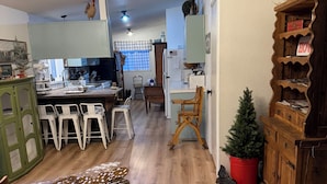 A kitchen with a dining area, wooden flooring, and a small Christmas tree. - Country Escape on 32 Acres/Trough Pool, Hot Tub & Stunning Views (Dayton)