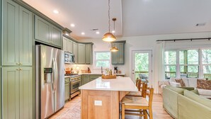 A spacious kitchen with green cabinets, a stainless steel refrigerator, and a large island. - 4 Mi to Ski Sapphire! Lakefront Cabin w/ Dock (Sapphire)