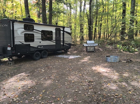 Property grounds. A well-maintained, cozy camper in a secluded location near state land