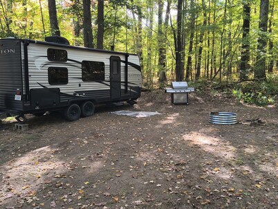 A well-maintained, cozy camper  in a secluded location near state land