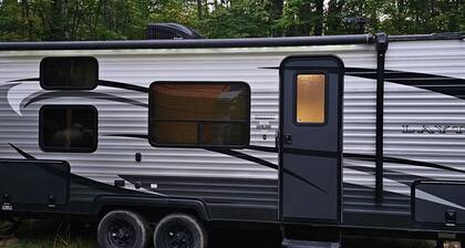 A well-maintained, cozy camper in a secluded location near state land