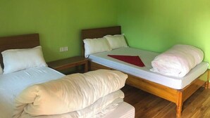 A room with two single beds, each with white bedding and a wooden headboard. - Lake Wave Cottage & Resturent (Lekhnath)