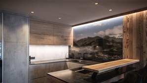 Una cocina moderna con encimera de madera, armarios empotrados y un amplio ventanal con vistas a la montaña.