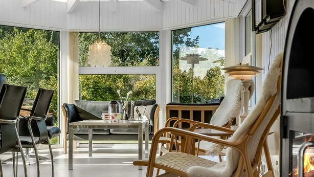 A modern interior with a dining area, chairs, a table, and a fireplace. - "Martina" - 500m from the sea by Interhome (Jerup)