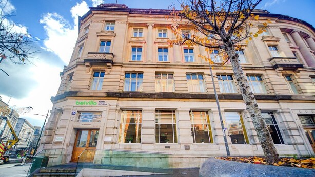 A historic building with a classic architectural style, featuring large windows and a prominent entrance.