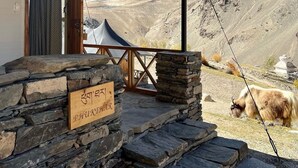 A stone-constructed building with a sign reading "PHUKKHAR". - Tara Mountain Sarai (Kargil)