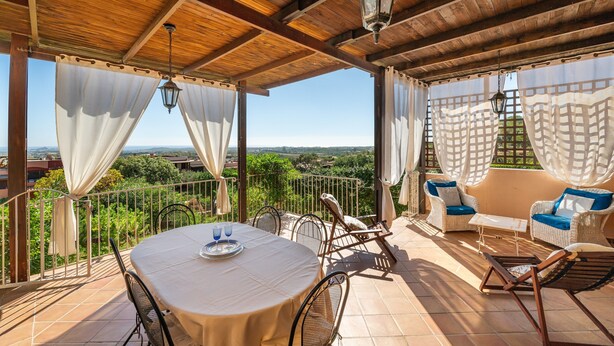A covered outdoor patio with a table, chairs, and a sofa. - Holiday Home 'Iris 8 Is Molas Golf Resort' with Sea View, Private Terrace and Wi-Fi (Is Molas)