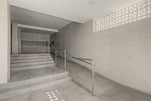 A modern staircase with metal railings and a patterned wall design. - Studio Apartment 'Sol Y Breeze' with Sea View, Wi-Fi and Air Conditioning (Torre del Mar)