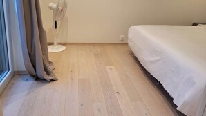 A room with a bed, a standing fan, and a window with curtains. - Oslo Center, Norway, your second home. (Oslo)
