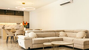 A modern living room with a sectional sofa, two round coffee tables, and a minimalist design. - Wonderful private villa for 10 guests with WIFI, A/C, private pool, TV and terrace (Dropuljici)