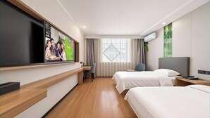 A hotel room with a flat-screen TV, two beds, a desk, and a window with curtains. - GreenTree Inn Express Hotel (Yangzhou Slender West Hunan Branch) (Yangzhou)