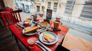 A table with breakfast items including toast, cheese, ham, and various drinks. - Triple apartment one block from the Main Sq. (Salta)