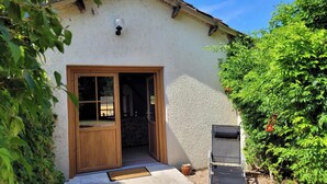 A rustic building with a wooden door and a small porch.