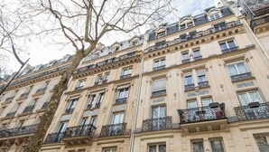A multi-story building with ornate balconies and a classic architectural style.