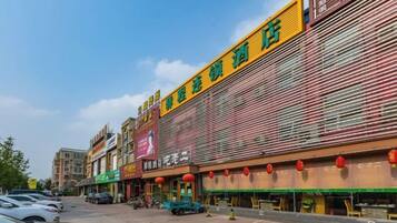 A commercial building with multiple storefronts, including a visible restaurant and a hotel.