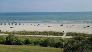 A beach with umbrellas and people. - SC5 Oceanfront beautiful condo right on the beach (Myrtle Beach)