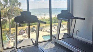 A gym with treadmills and a view of the beach. - SC5 Oceanfront beautiful condo right on the beach (Myrtle Beach)