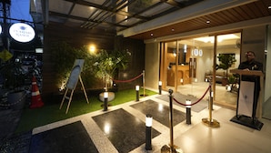 A hotel entrance with a reception desk, a sign indicating the name "PUNJABI RASOI," and a red rope barrier. - SIVANTA BY BOMBAY GROUP OF HOTELS NAGPUR (Nagpur)