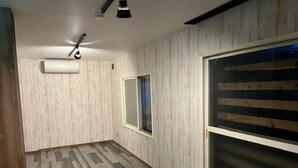 A room with a herringbone-patterned floor, a window with a view, and a ceiling fan. - YOUTEI2 (Rusutsu)